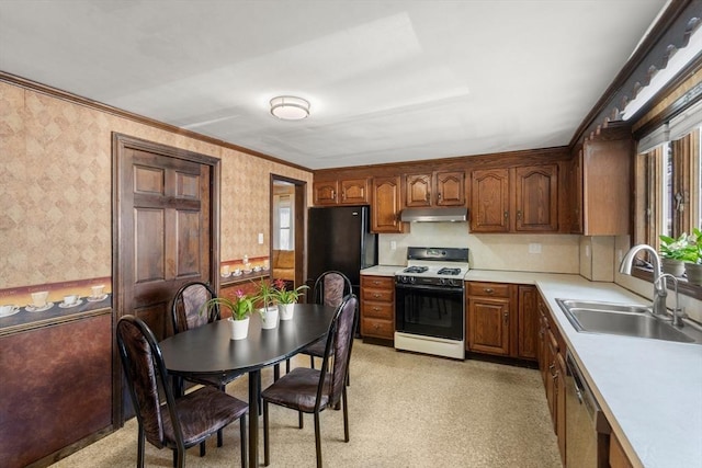 349 Pleasant St, Milton, MA 02186 - kitchen with white gas stove, under cabinet range hood, wallpapered walls, light countertops, and dishwasher