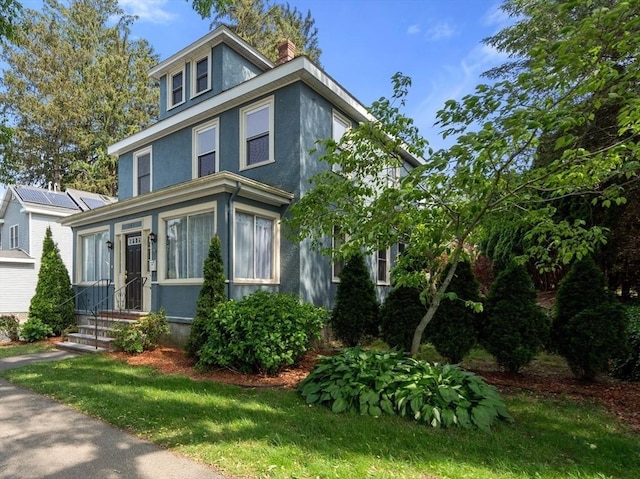 349 Pleasant St, Milton, MA 02186 - view of front facade with stucco siding and a chimney
