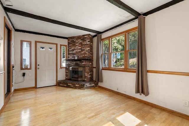 349 Pleasant St, Milton, MA 02186 - unfurnished living room with beamed ceiling, light wood-style floors, and a brick fireplace