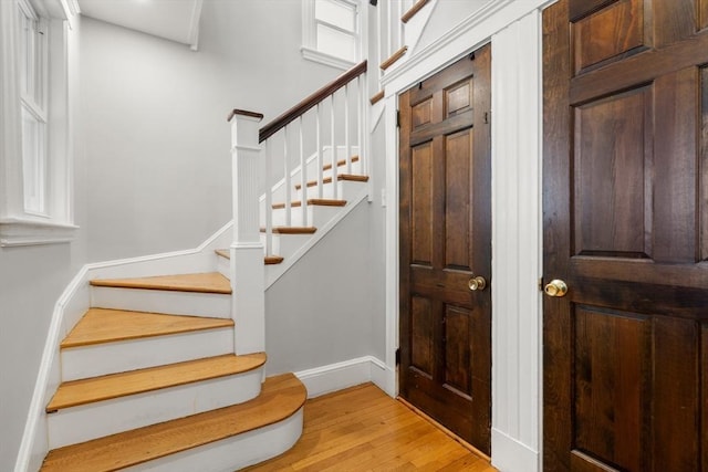 349 Pleasant St, Milton, MA 02186 - foyer entrance with light wood-style floors and stairs