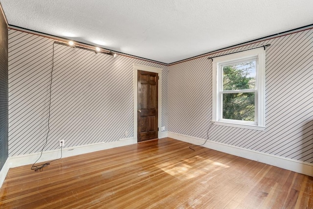 349 Pleasant St, Milton, MA 02186 - empty room featuring hardwood / wood-style floors and a textured ceiling