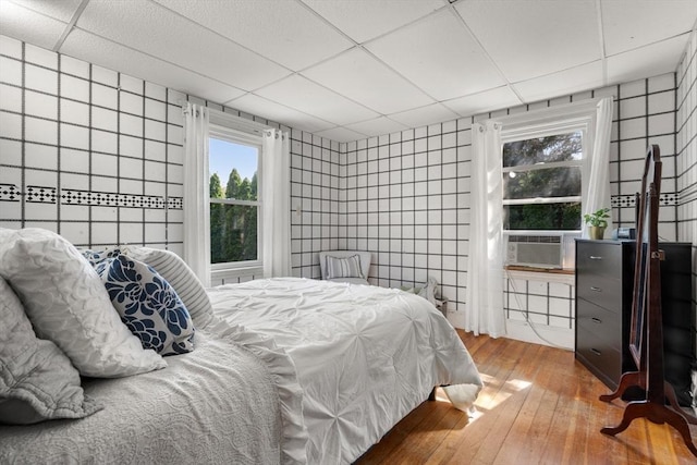 349 Pleasant St, Milton, MA 02186 - bedroom with hardwood / wood-style flooring, a drop ceiling, tile walls, and cooling unit