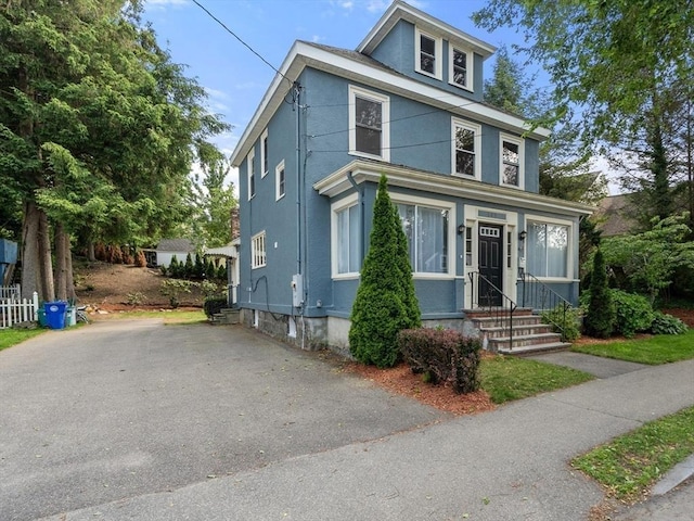349 Pleasant St, Milton, MA 02186 - traditional style home featuring stucco siding, entry steps, and asphalt driveway