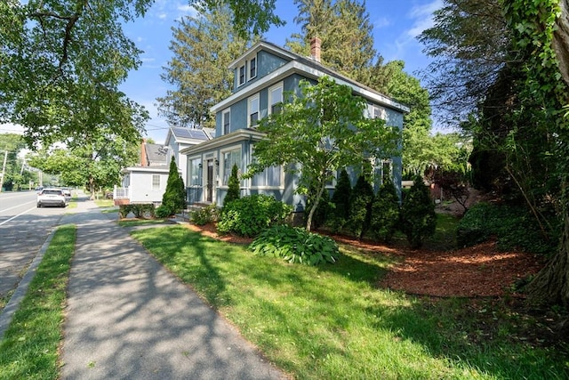 349 Pleasant St, Milton, MA 02186 - view of property exterior featuring stucco siding and a chimney