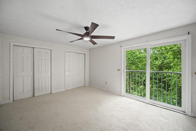 585 Turnpike St Unit 13, Easton, MA 02375 - unfurnished bedroom featuring two closets, baseboards, carpet floors, and ceiling fan