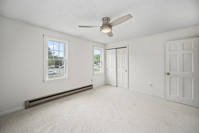 585 Turnpike St Unit 13, Easton, MA 02375 - unfurnished bedroom featuring a baseboard radiator, carpet, a closet, baseboards, and a ceiling fan