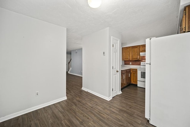 585 Turnpike St Unit 13, Easton, MA 02375 - kitchen featuring white appliances, baseboards, dark wood-style flooring, brown cabinets, and light countertops