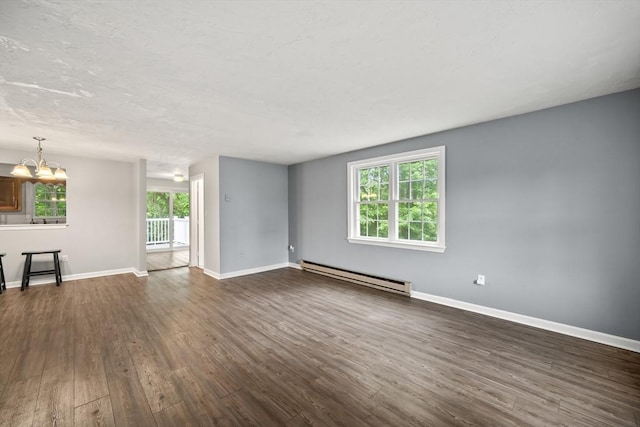 585 Turnpike St Unit 13, Easton, MA 02375 - unfurnished living room featuring a baseboard heating unit, dark wood-type flooring, a chandelier, and baseboards
