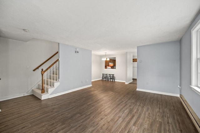 585 Turnpike St Unit 13, Easton, MA 02375 - unfurnished living room featuring baseboard heating, dark wood-type flooring, stairs, a chandelier, and baseboards