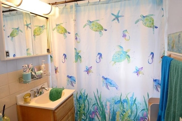 24 Dorothy Ave, Dracut, MA 01826 - full bathroom with vanity, decorative backsplash, and curtained shower