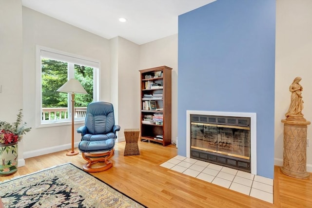 14 Michaels Grn Unit 14, Woburn, MA 01801 - living area featuring wood finished floors, baseboards, a fireplace with flush hearth, and recessed lighting