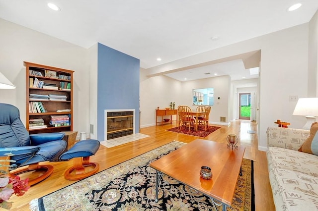 14 Michaels Grn Unit 14, Woburn, MA 01801 - living room with wood finished floors, a tile fireplace, baseboards, and recessed lighting