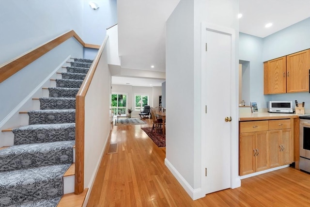 14 Michaels Grn Unit 14, Woburn, MA 01801 - stairs featuring wood finished floors, baseboards, and recessed lighting