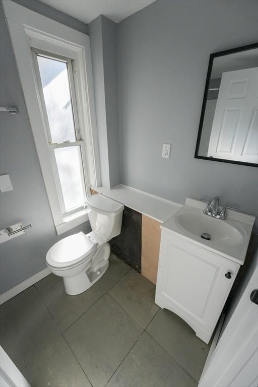 bathroom featuring toilet, tile patterned floors, and vanity