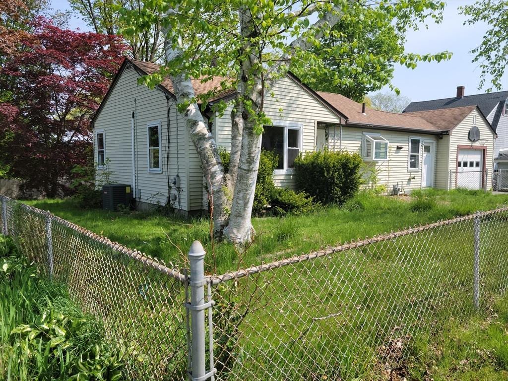 34 Doherty Ave, Somerset, MA 02726 - view of front of home featuring an attached garage, a fenced backyard, and a chimney
