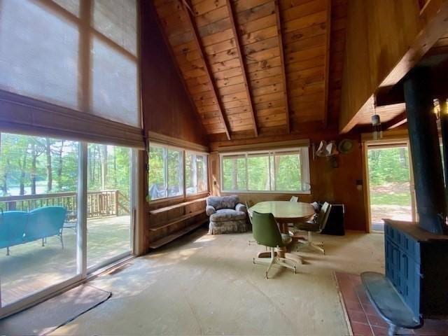 64E Old Princeton Rd, Hubbardston, MA 01452 - sunroom featuring a wood stove, a wood ceiling with exposed beams, high vaulted ceiling, and wooden walls