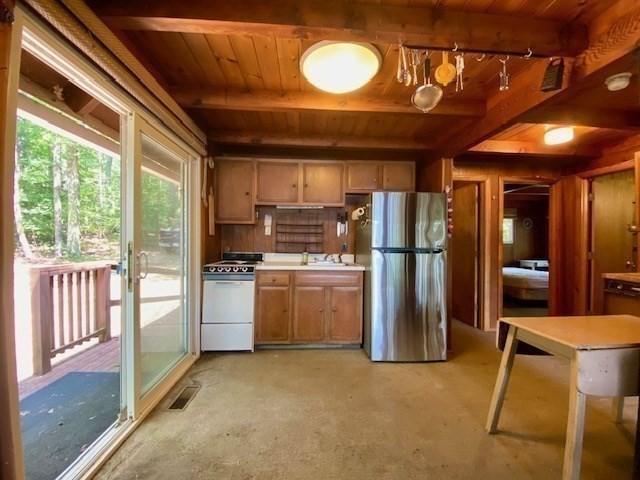 64E Old Princeton Rd, Hubbardston, MA 01452 - kitchen with freestanding refrigerator, white range with gas cooktop, a wood ceiling with exposed beams, light countertops, and brown cabinetry