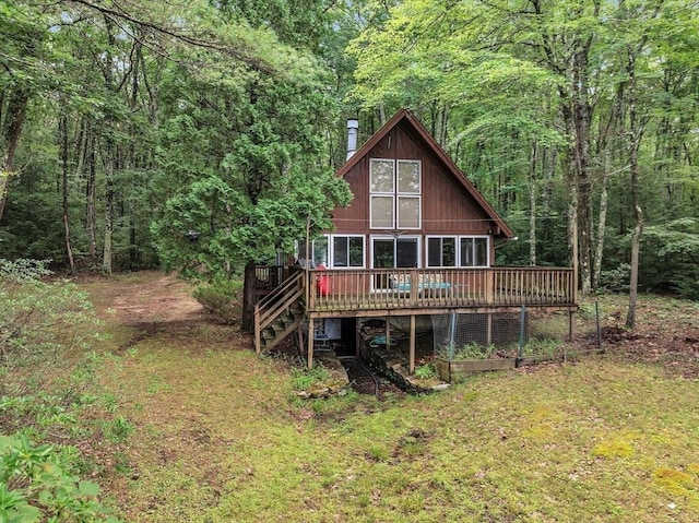 64E Old Princeton Rd, Hubbardston, MA 01452 - rear view of house with a deck, a chimney, a view of trees, and a lawn