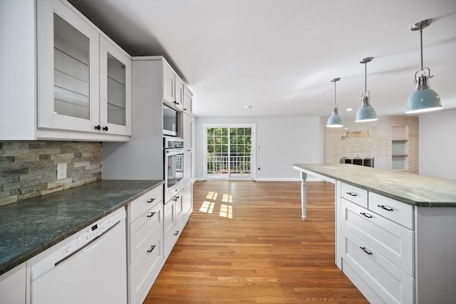 34 Clubhouse Ln, Natick, MA 01760 - kitchen featuring appliances with stainless steel finishes, light wood-type flooring, backsplash, hanging light fixtures, and glass insert cabinets