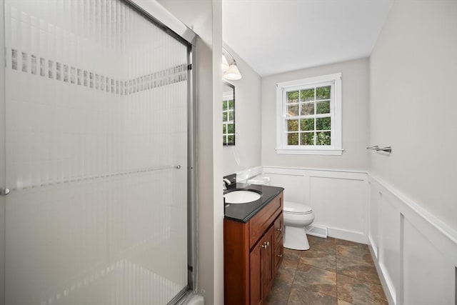 34 Clubhouse Ln, Natick, MA 01760 - full bathroom featuring vanity, a shower stall, stone finish flooring, wainscoting, and a decorative wall