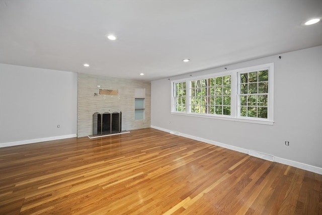 34 Clubhouse Ln, Natick, MA 01760 - unfurnished living room featuring wood finished floors, a large fireplace, and recessed lighting