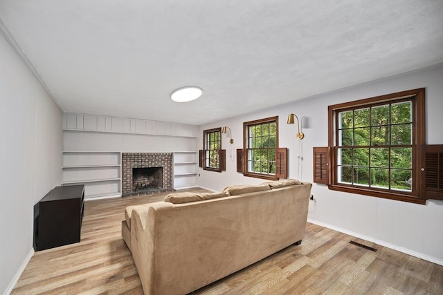 34 Clubhouse Ln, Natick, MA 01760 - living area with light wood-type flooring and a brick fireplace
