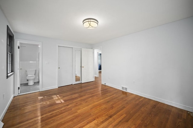 34 Clubhouse Ln, Natick, MA 01760 - unfurnished bedroom with wood finished floors, ensuite bath, and a closet