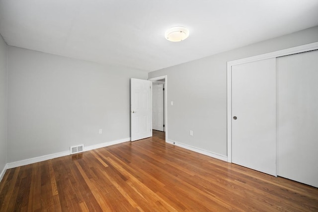 34 Clubhouse Ln, Natick, MA 01760 - unfurnished bedroom with wood finished floors and a closet