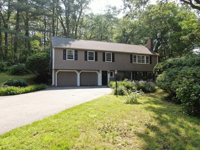 34 Clubhouse Ln, Natick, MA 01760 - view of front of property with asphalt driveway, a chimney, an attached garage, and a front yard