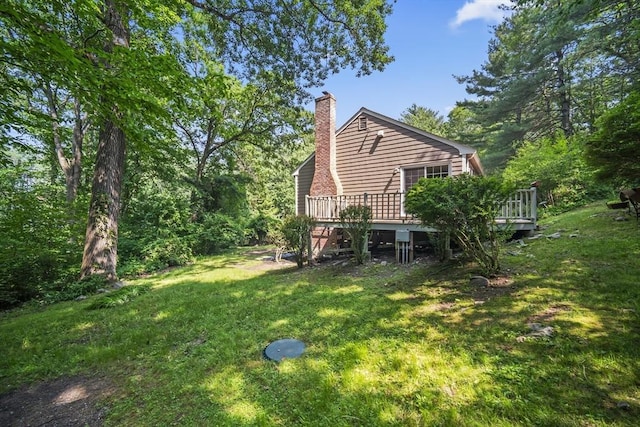 34 Clubhouse Ln, Natick, MA 01760 - back of property with a chimney, a lawn, and a wooden deck