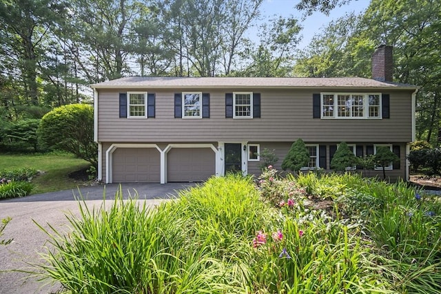 34 Clubhouse Ln, Natick, MA 01760 - view of front of property featuring a chimney, asphalt driveway, and a garage