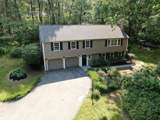 34 Clubhouse Ln, Natick, MA 01760 - view of front of house with asphalt driveway, a chimney, and a garage