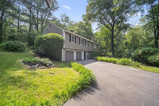 34 Clubhouse Ln, Natick, MA 01760 - view of front facade featuring an attached garage, driveway, a chimney, and a front lawn