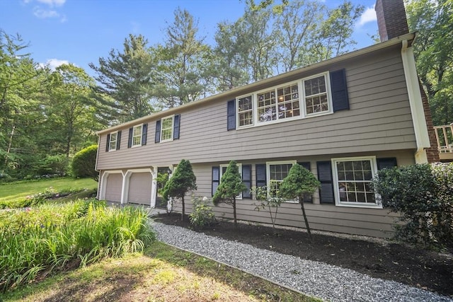 34 Clubhouse Ln, Natick, MA 01760 - colonial home with a chimney, an attached garage, and driveway
