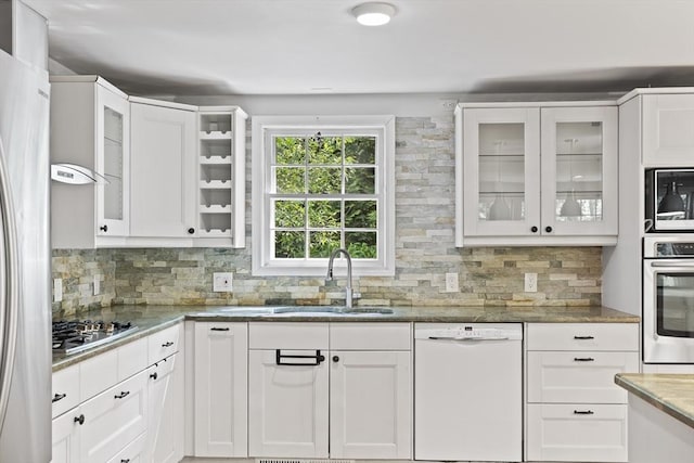 34 Clubhouse Ln, Natick, MA 01760 - kitchen featuring appliances with stainless steel finishes, white cabinetry, backsplash, and light stone countertops