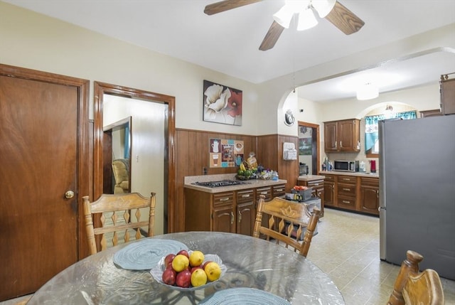 kitchen featuring stainless steel appliances, ceiling fan, and light countertops