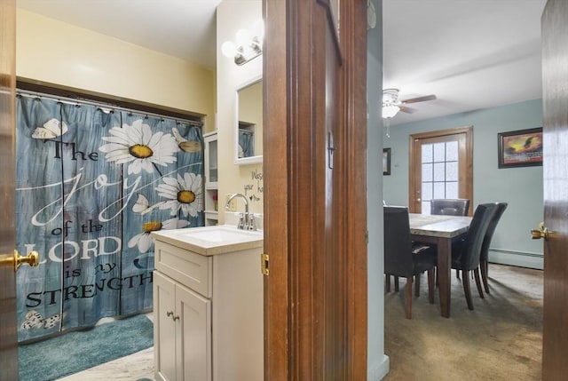 full bathroom featuring vanity, a shower with shower curtain, a ceiling fan, and baseboard heating