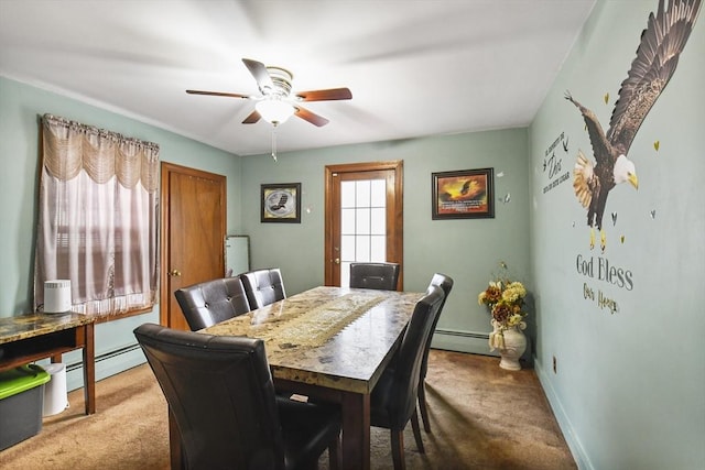 dining room with baseboards, light carpet, baseboard heating, and a ceiling fan