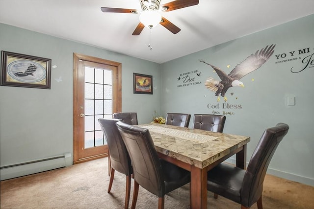 dining area featuring a baseboard heating unit, light colored carpet, baseboards, and ceiling fan