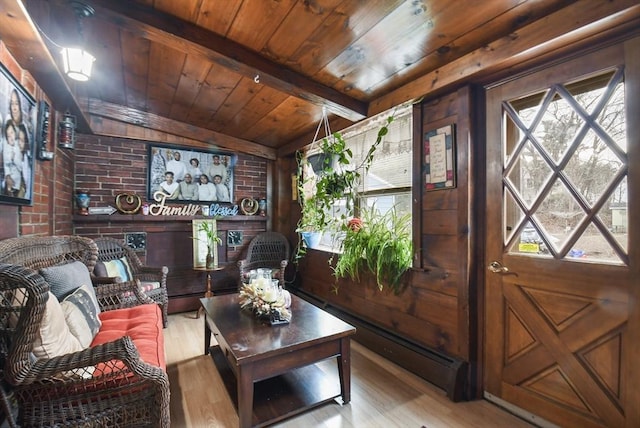 living area with wooden ceiling, brick wall, lofted ceiling with beams, and wood finished floors