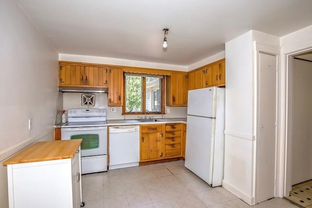 112 Harmon Ave, Springfield, MA 01118 - kitchen with white appliances, under cabinet range hood, and brown cabinets