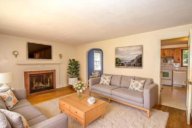 112 Harmon Ave, Springfield, MA 01118 - living area with wood finished floors, healthy amount of natural light, arched walkways, and a brick fireplace