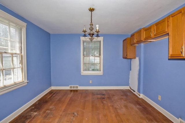 112 Harmon Ave, Springfield, MA 01118 - unfurnished dining area with dark wood finished floors and baseboards