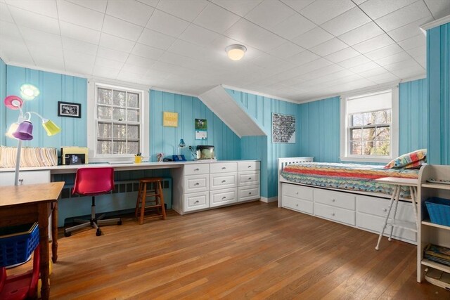 bedroom with multiple windows, hardwood / wood-style floors, a desk, and ornamental molding