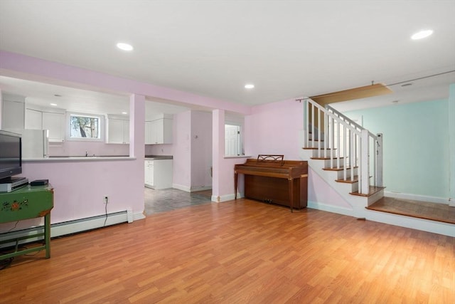 living room with light wood finished floors, stairway, baseboards, and recessed lighting