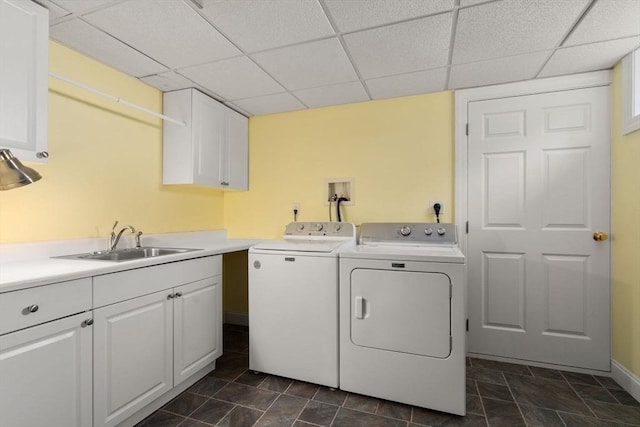 laundry area with washing machine and clothes dryer, cabinet space, and baseboards