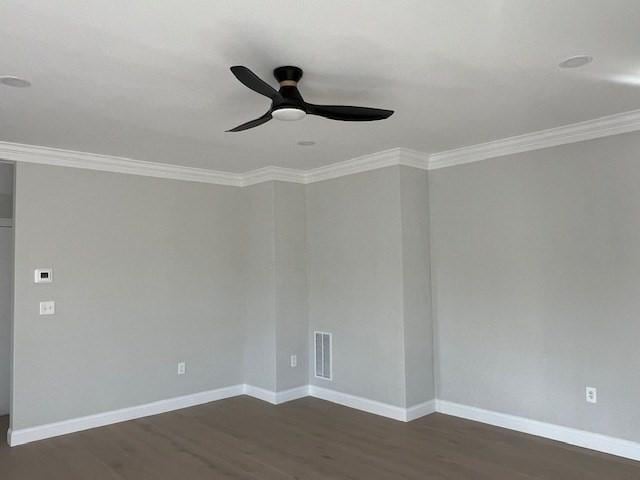 unfurnished room with ornamental molding, dark wood-type flooring, and ceiling fan