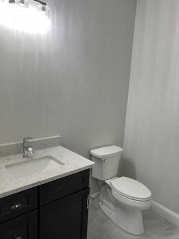 bathroom featuring toilet and vanity