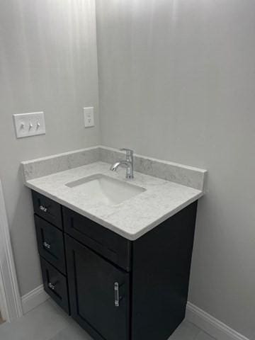 bathroom with tile patterned floors and vanity