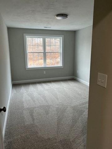 spare room with light colored carpet